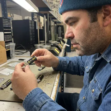 Technician preparing custom printed USB drives