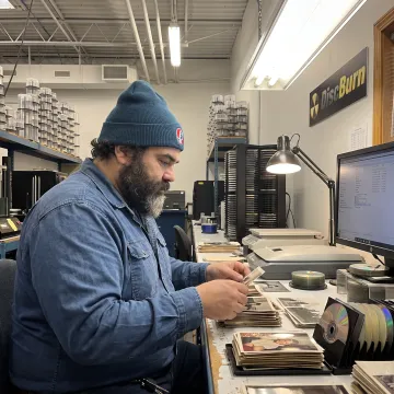 Technician organizing photos for digitization