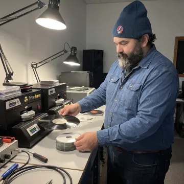 Audio technician preparing vinyl and CDs