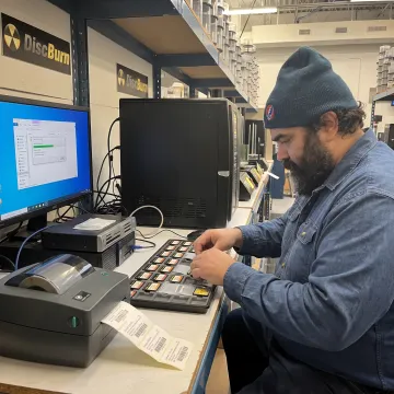 Technician preparing Compact Flash cards for data loading