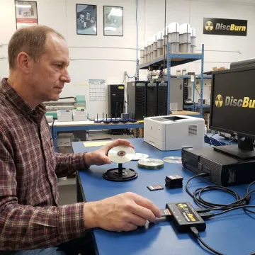 Technician transferring DVD files to an SD card