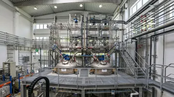 Specialty chemical manufacturing facility with reactor equipment and processing infrastructure