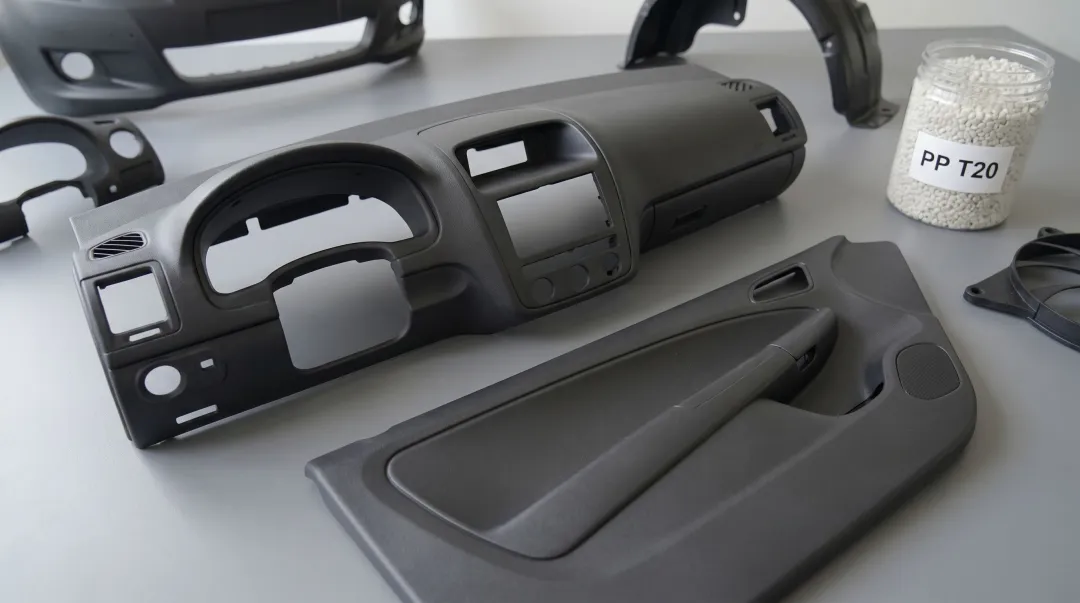 Polypropylene automotive dashboard and door panel components showing talc-filled plastic parts