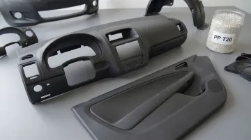 Polypropylene automotive dashboard and door panel components showing talc-filled plastic parts