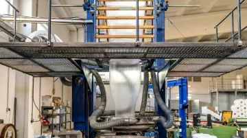 Industrial blown film extrusion line producing polyethylene packaging film rolls