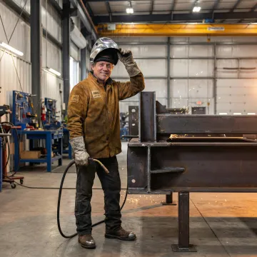 AWS certified welder performing custom metal fabrication in a professional industrial shop in West Columbia, SC