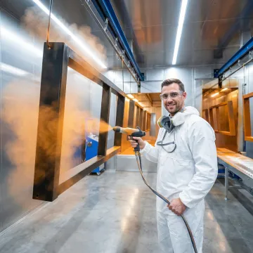 Industrial powder coating and paint shop facility with metal parts being coated in Michigan