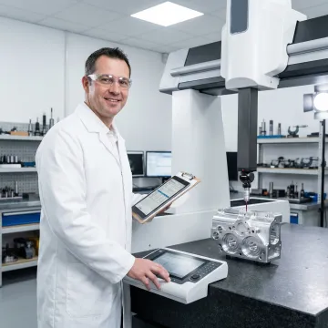Certified quality inspector using CMM equipment to verify precision machined component dimensions