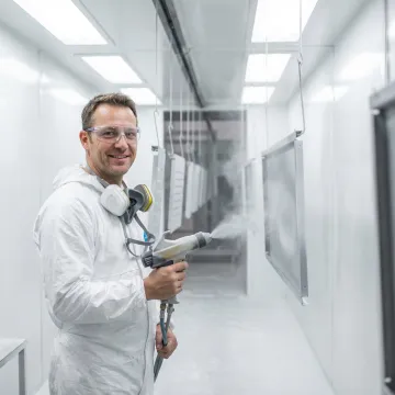 Powder coating application on metal appliance components in an industrial facility