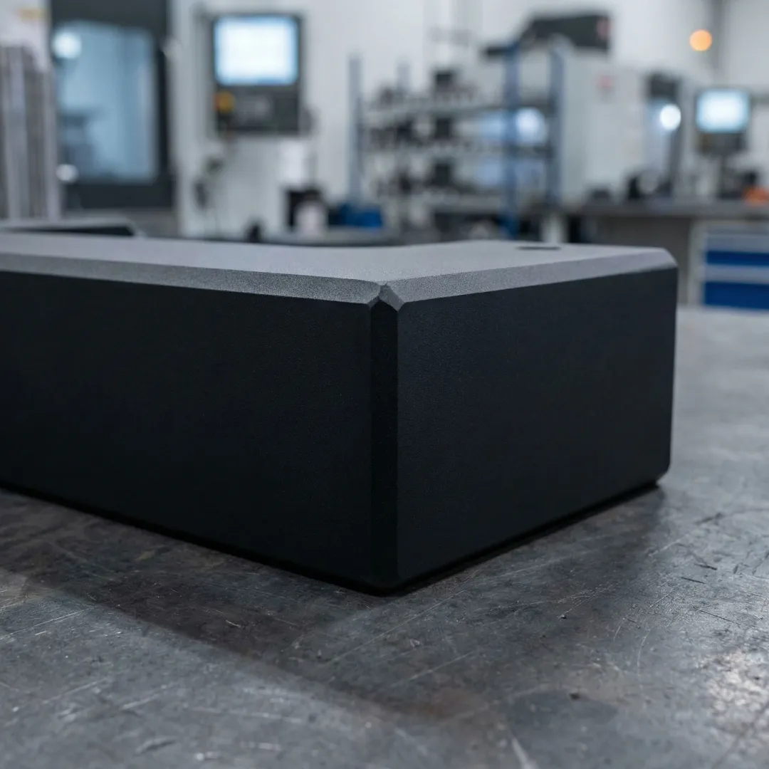 Close-up of a powder-coated metal component with a smooth, durable finish in an industrial setting
