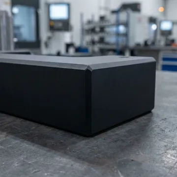 Close-up of a powder-coated metal component with a smooth, durable finish in an industrial setting