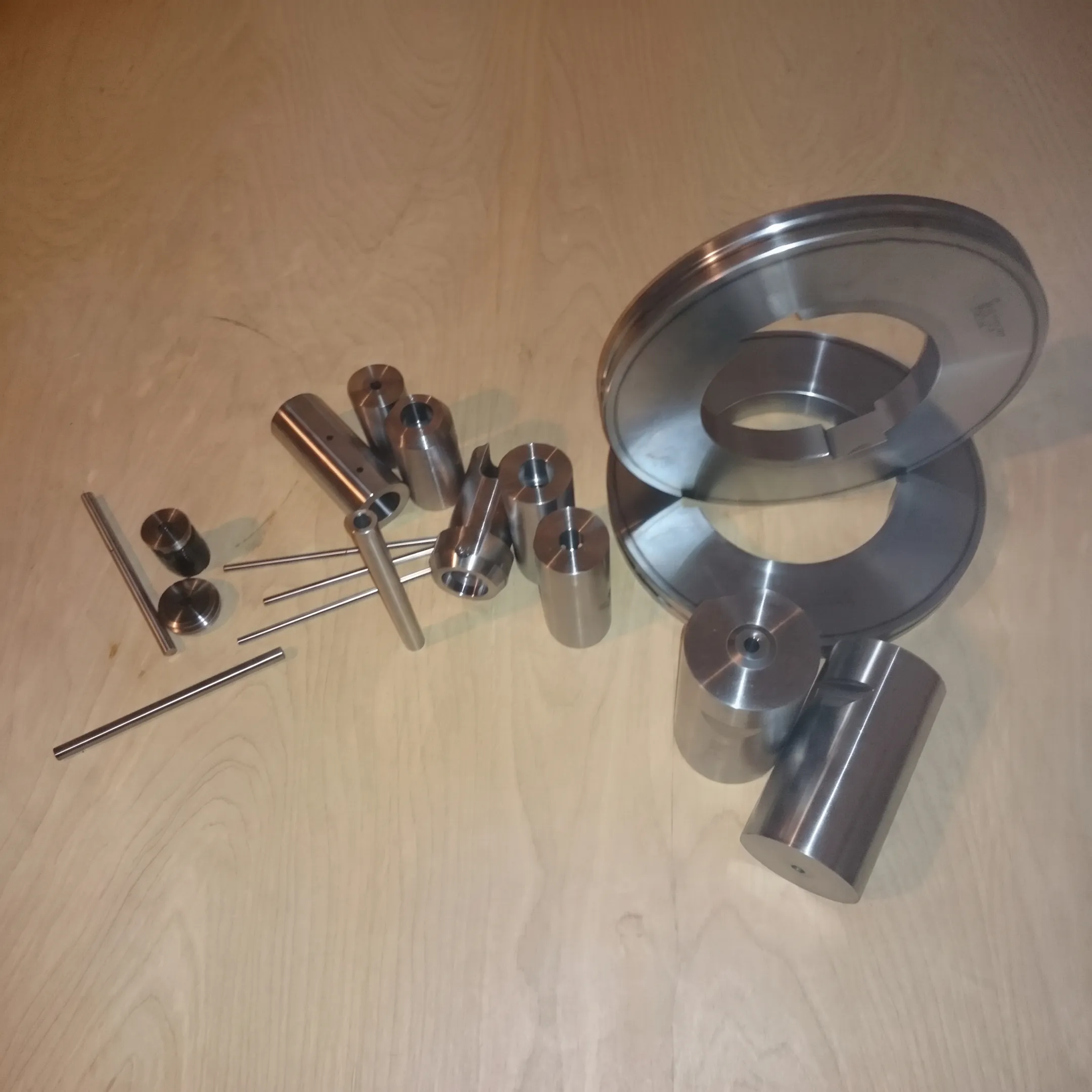 Machined stamping die and precision tooling components on a workbench