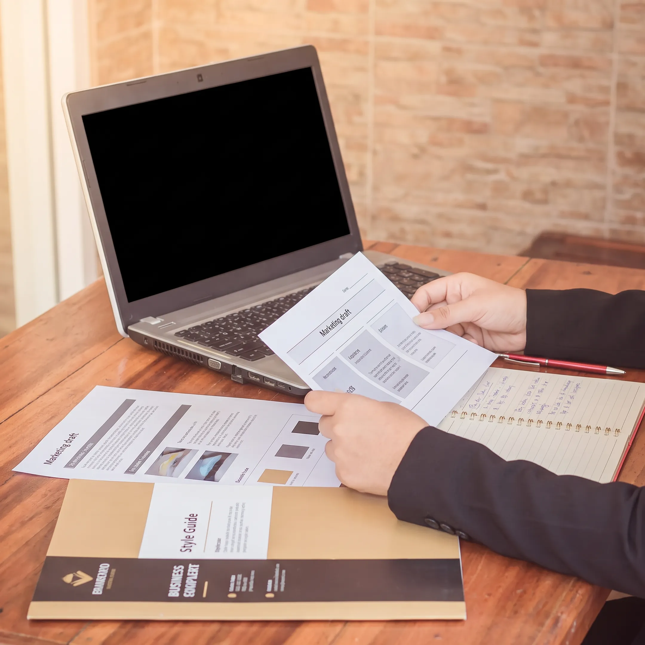 Content strategist reviewing business messaging and marketing materials at a desk