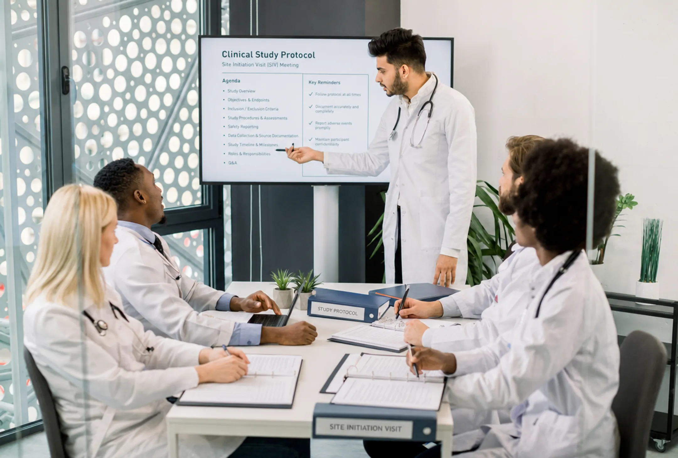Clinical research investigator meeting with site staff during trial initiation