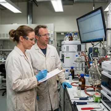 Scientists reviewing API process chemistry data in a laboratory