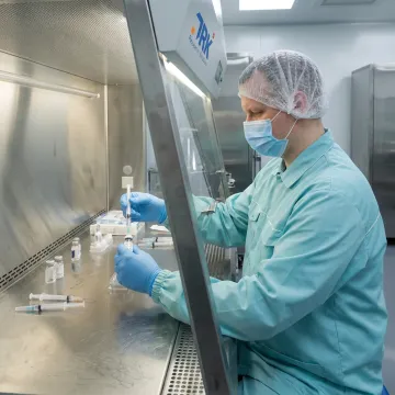 Scientist preparing a sterile pharmaceutical formulation