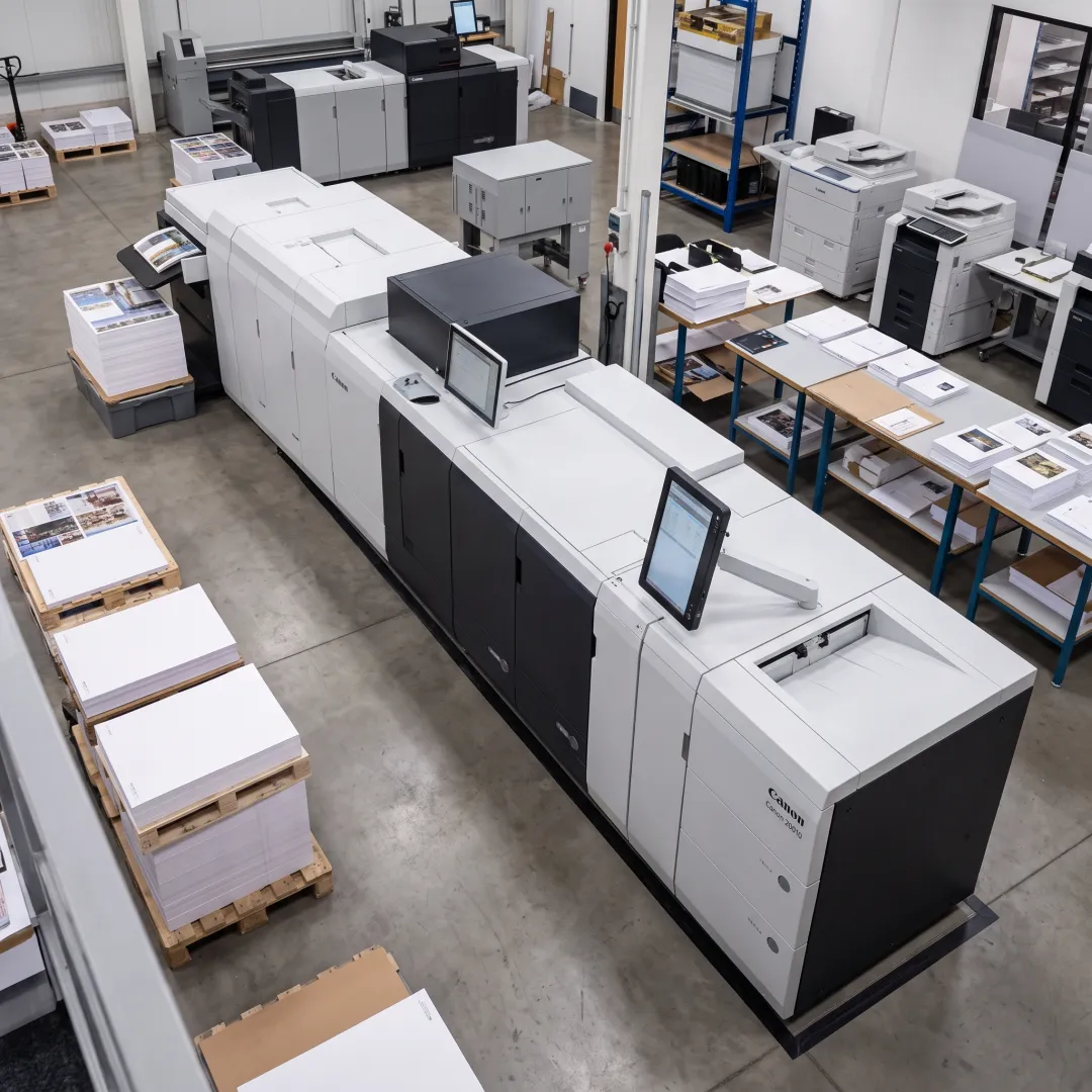 Bound business materials beside a printing press