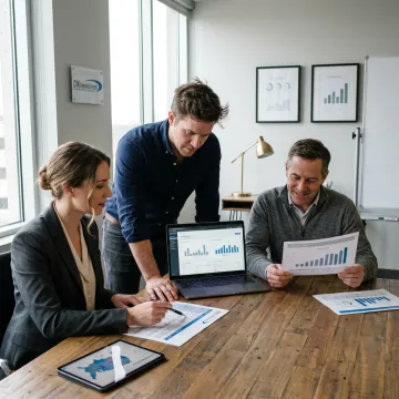 Advertising team reviewing campaign performance reports