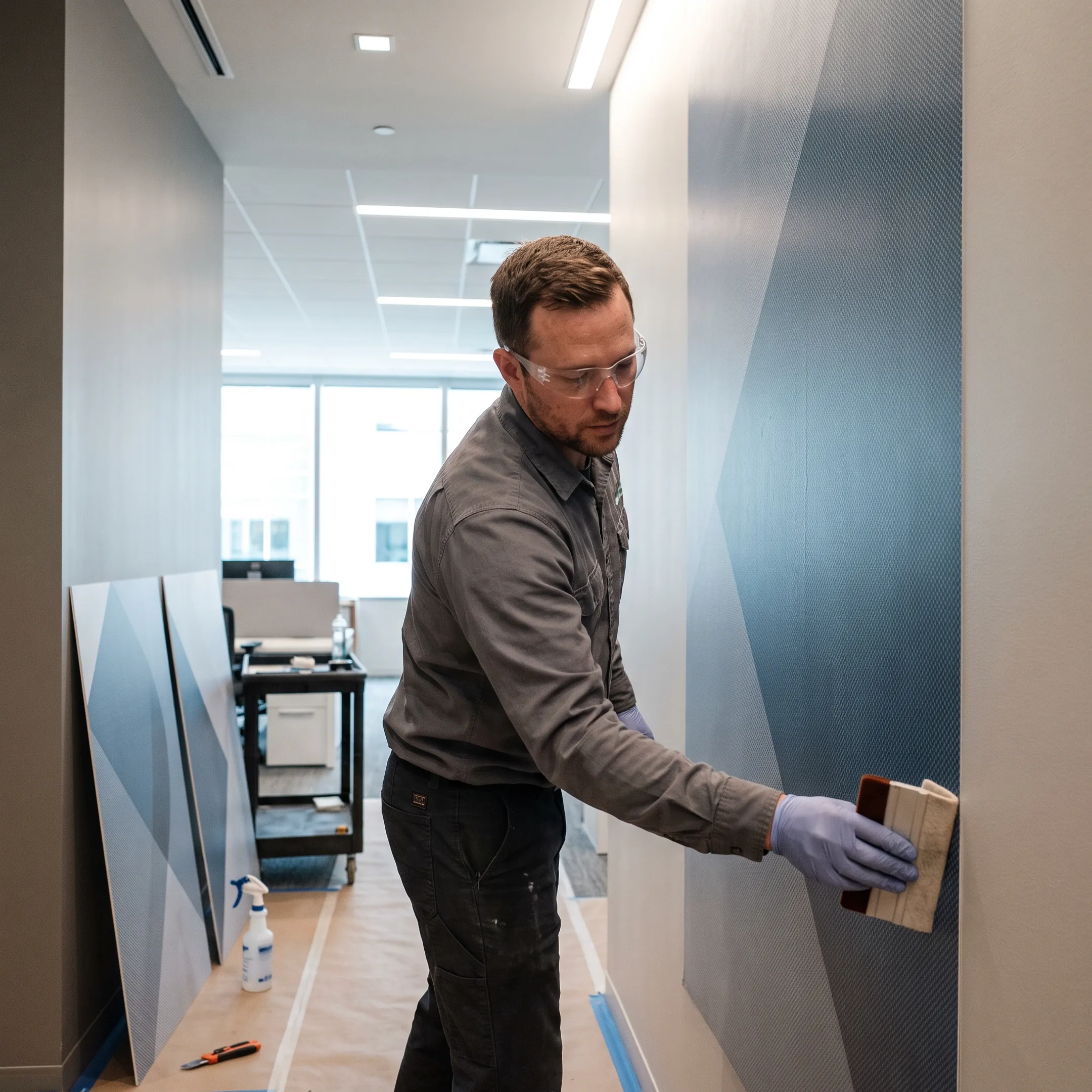 Large format wall graphic being installed in a business space
