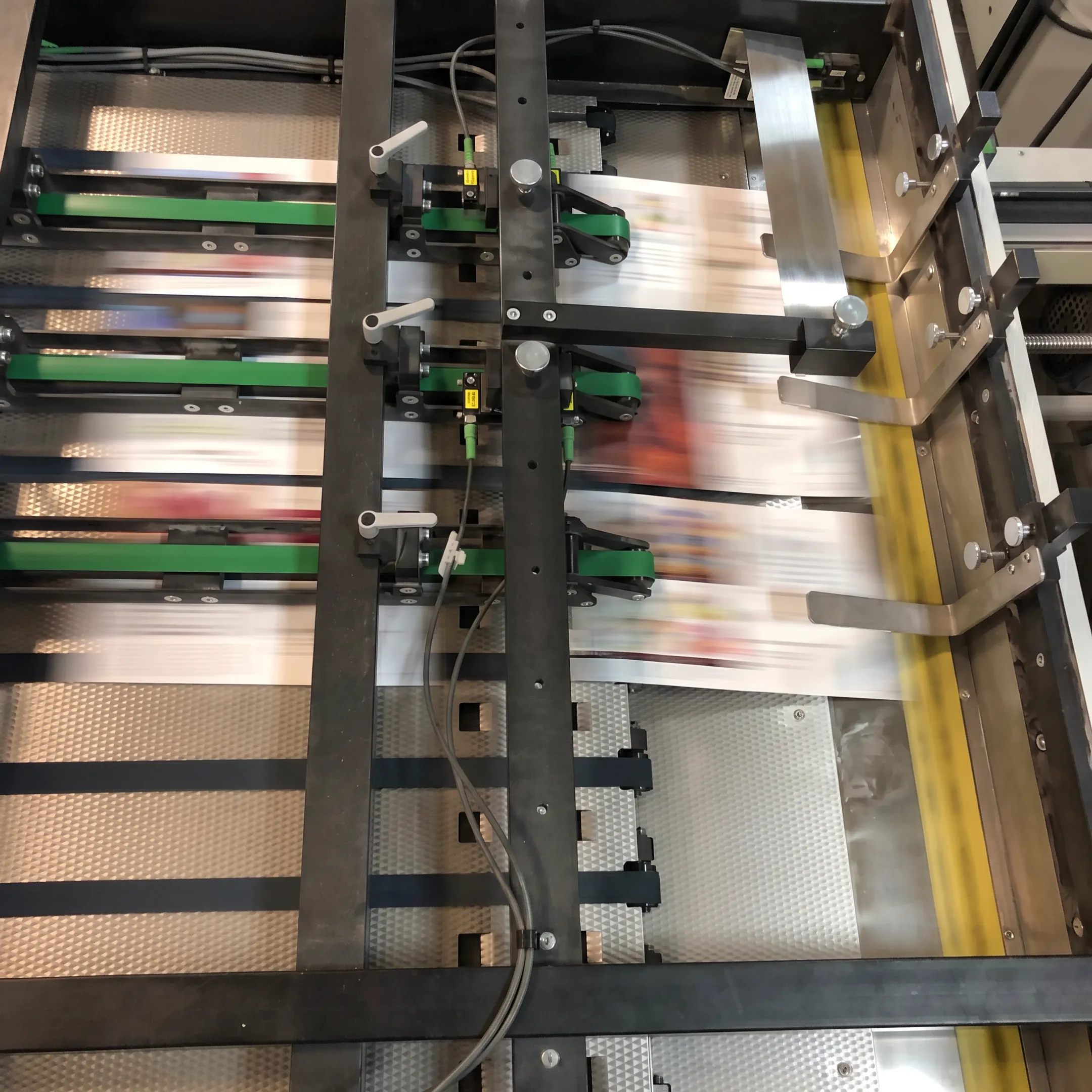 Personalized direct mail postcards moving through a commercial mailing workflow
