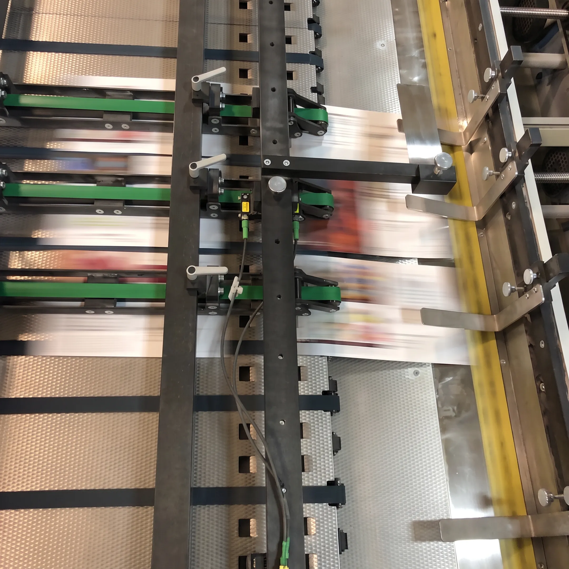 Personalized direct mail pieces moving through a print and mailing workflow