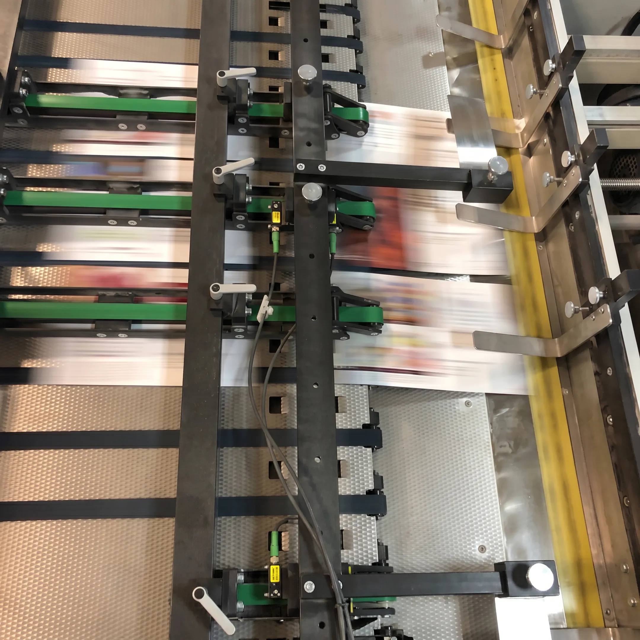 Printed direct mail pieces being personalized and prepared for USPS delivery