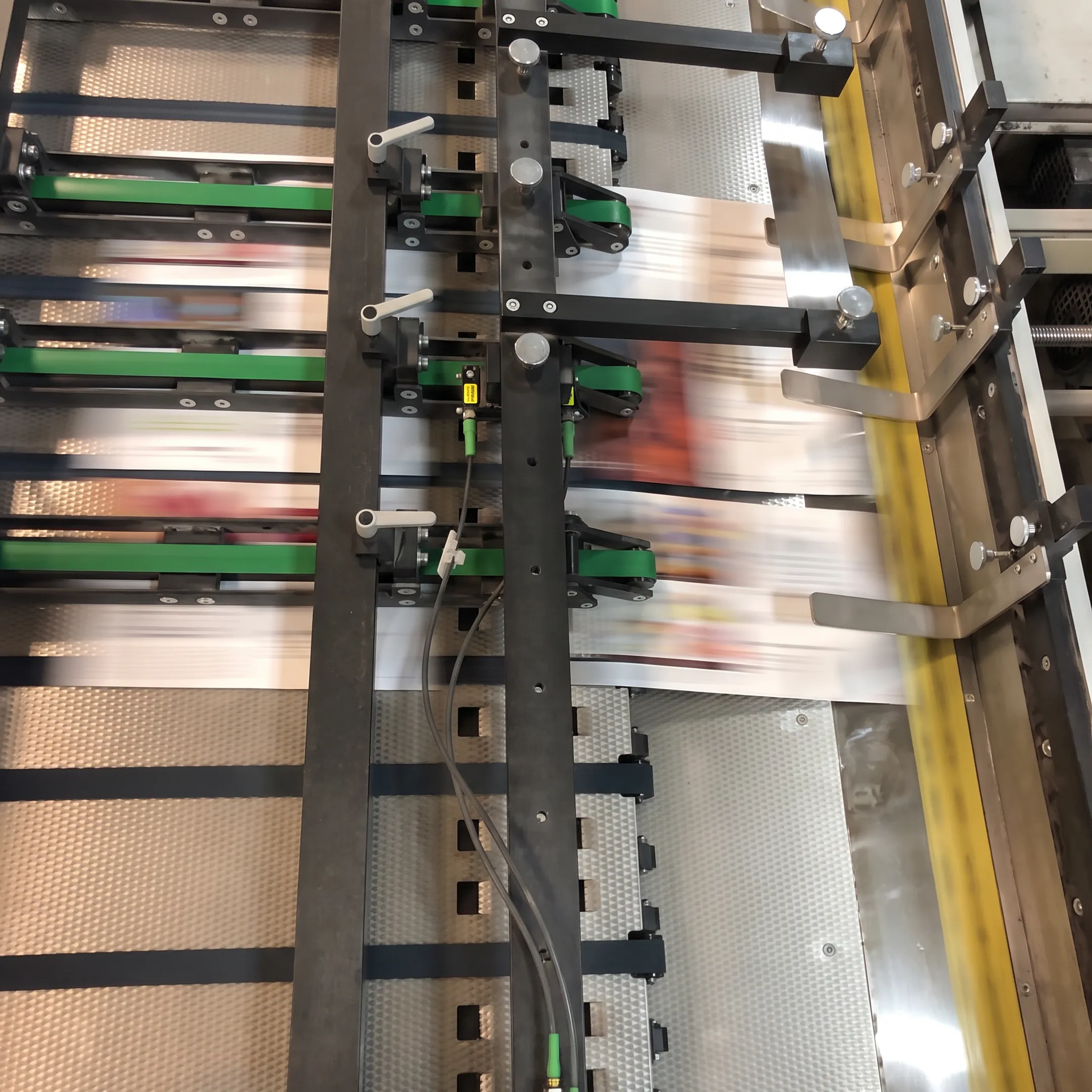 Printed booklet and bound report samples arranged on a commercial print production table