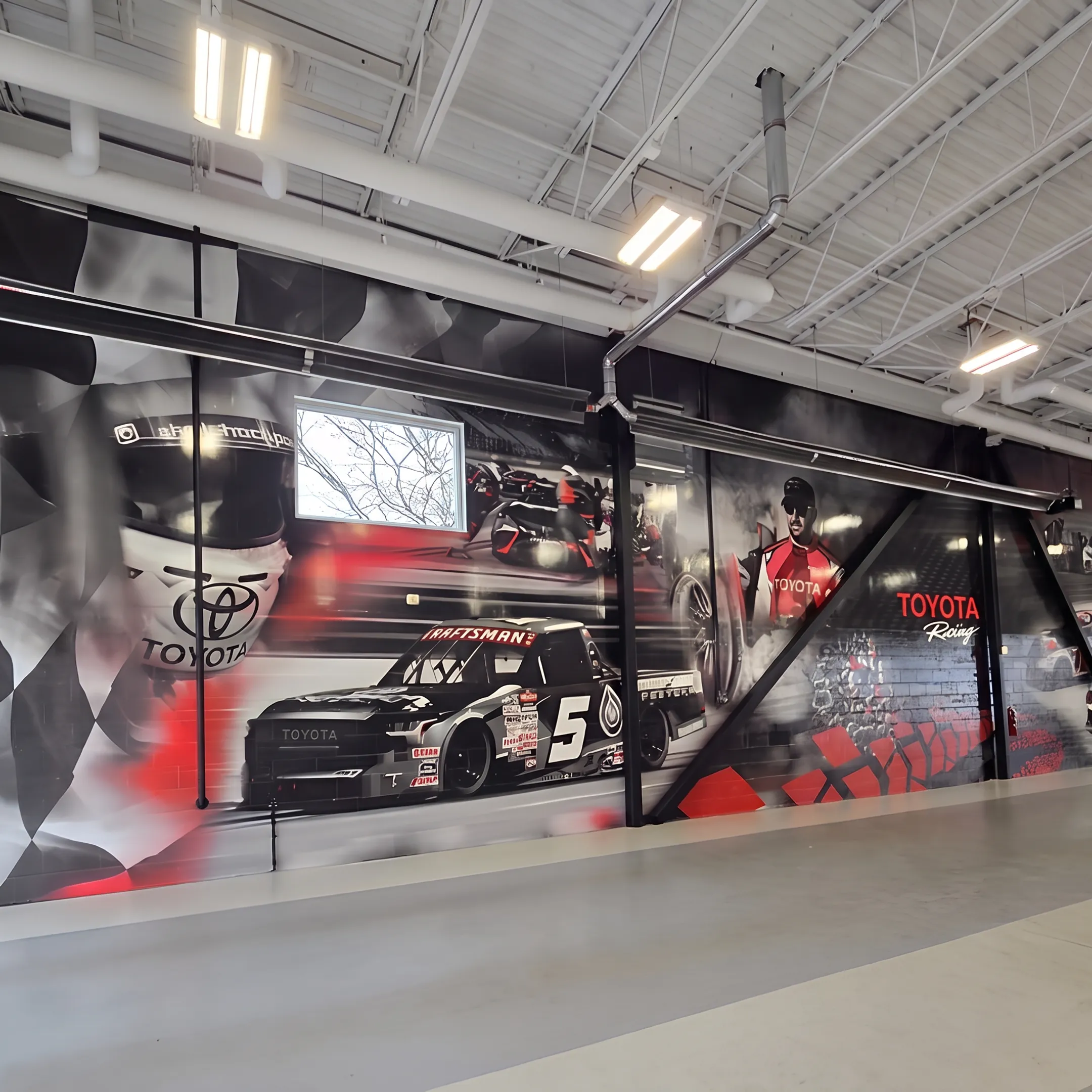 Custom wall mural and window graphics installed in a branded business interior