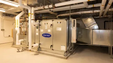 Commercial air handling unit installed in large facility mechanical room