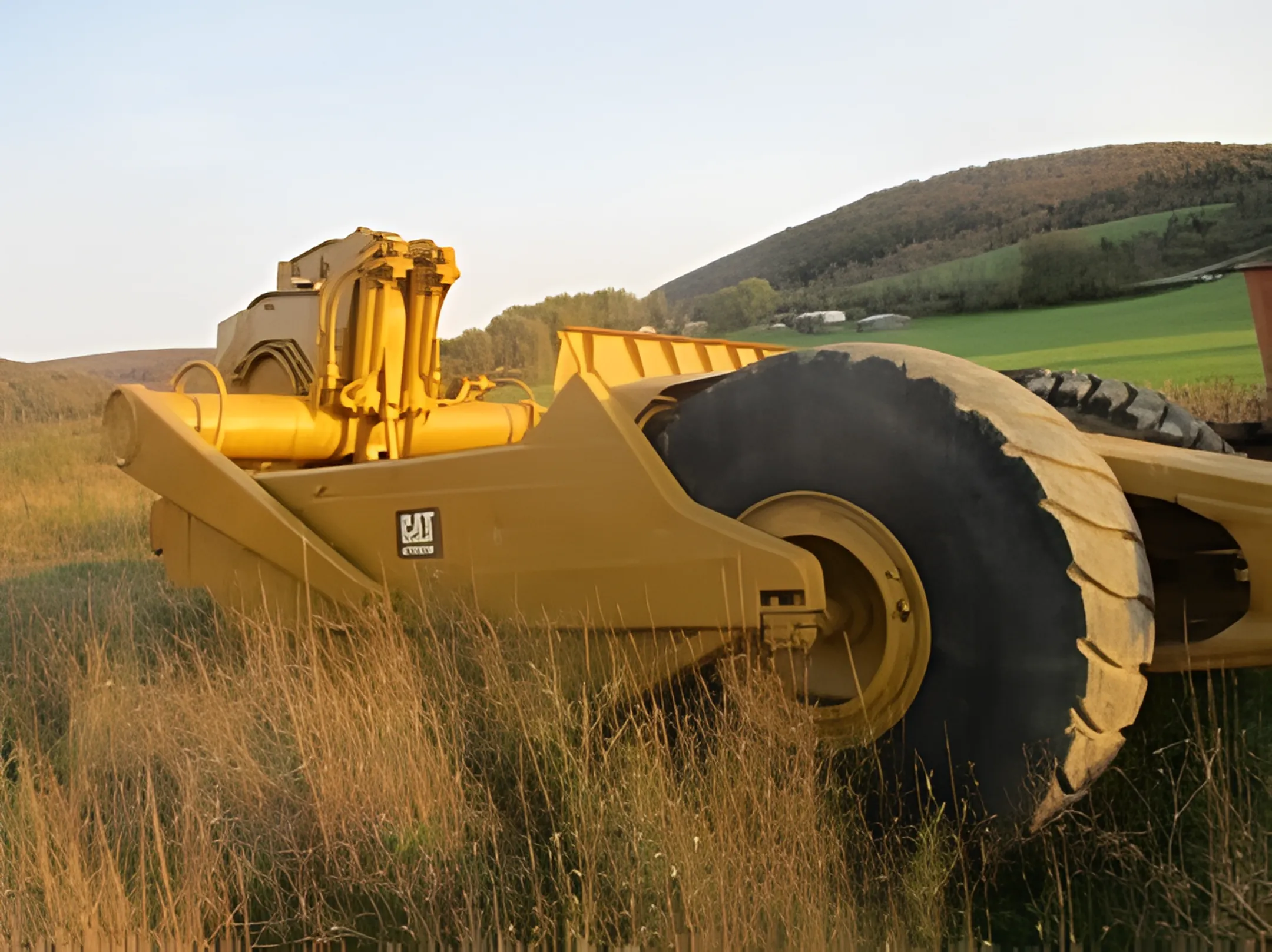 Material handling with a tractor scraper