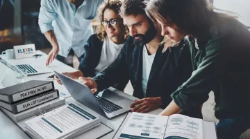 Elexes IVD regulatory consulting team reviewing FDA submission documentation in office