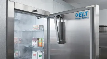 Kason SureClose walk-in cooler door closer hardware mounted on freezer door assembly
