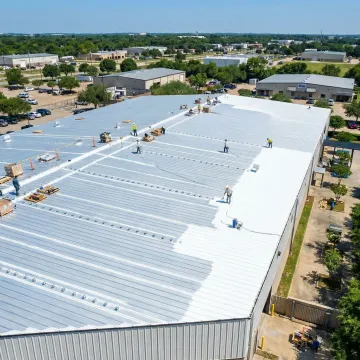 Close-up of repaired commercial metal roof seams and panels