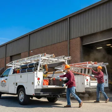 Emergency roofing crew responding to industrial facility leak with equipment and materials