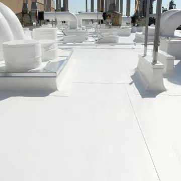 Close-up of commercial flat roof repair showing sealed membrane and professional workmanship