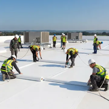 Technicians installing white membrane roofing