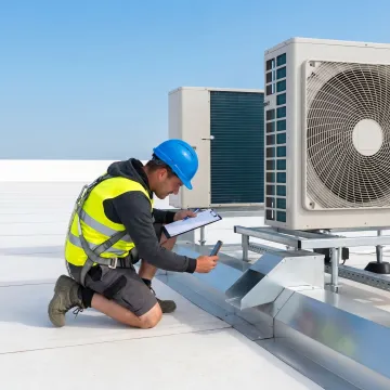 Technician documenting commercial roof conditions