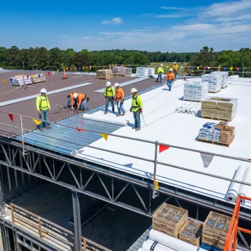 Commercial roofing installation process on new building
