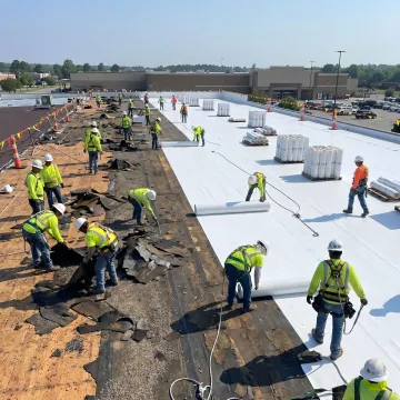 Commercial roofing team installing a new roof system