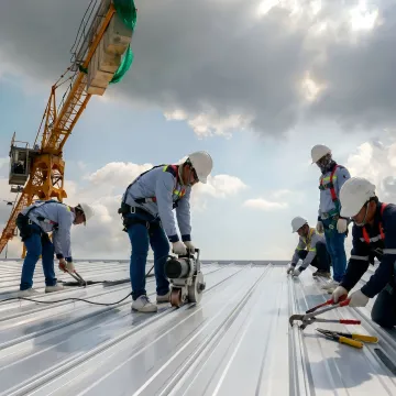 Commercial standing seam roof repair in progress