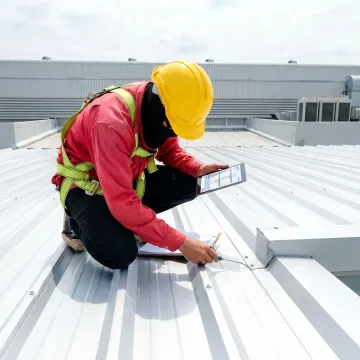 Commercial metal roof inspection in progress