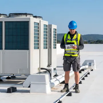 Inspector reviewing a commercial roof report