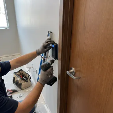 Security professional installing biometric access control system