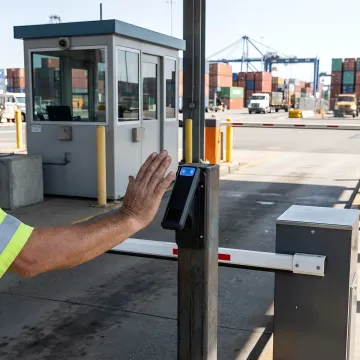 Modern port facility with biometric security gate system controlling vehicle and pedestrian access