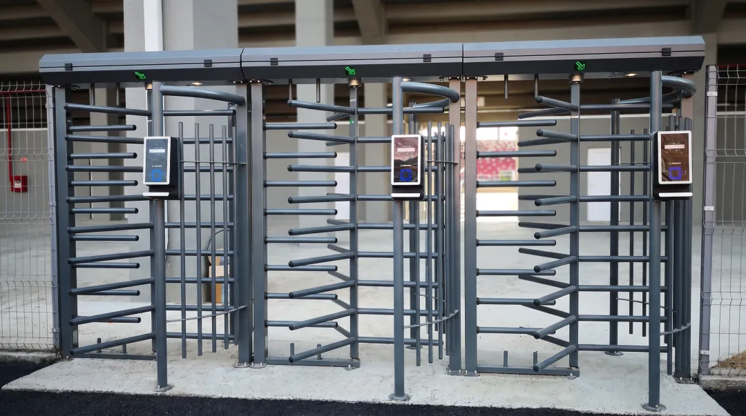 Modern turnstile entry system with card reader preventing tailgating at sports facility entrance