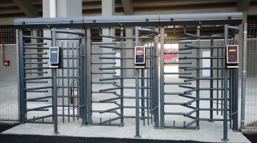 Modern turnstile entry system with card reader preventing tailgating at sports facility entrance