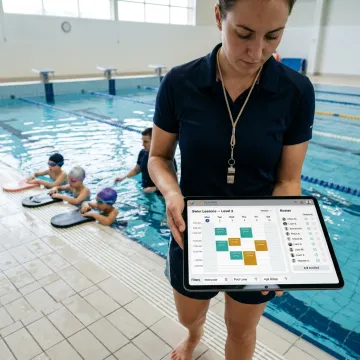 Swim instructor reviewing lesson schedules on a tablet