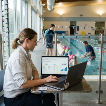 Swim school administrator reviewing lesson payments