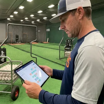 Coach reviewing baseball facility scheduling software
