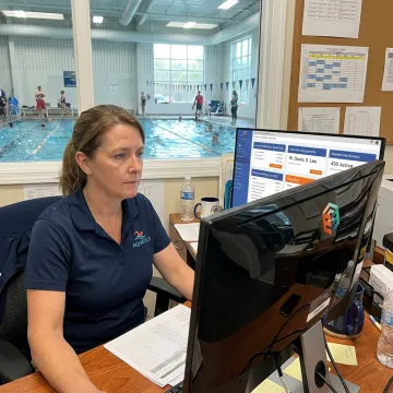 Aquatics manager reviewing swim program schedules
